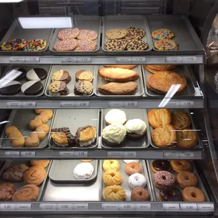 a variety of donuts in a display case