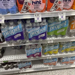 a shelf full of bottled drinks