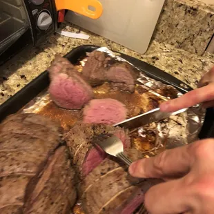 a person cutting a steak