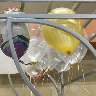 a young boy looking at balloons