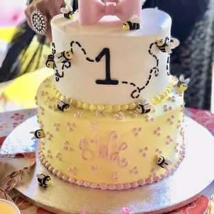 A custom made 1st BEE-day cake!!  Beautiful custom job with monogram, bees, #1, and delicate colors.