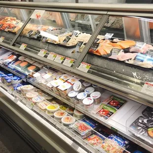 a refrigerated deli case filled with food