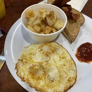 Two egg breakfast over medium with hash browns and bacon