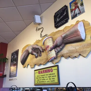 I like the nod to the Creation of Adam. Check out that warning sign, though.