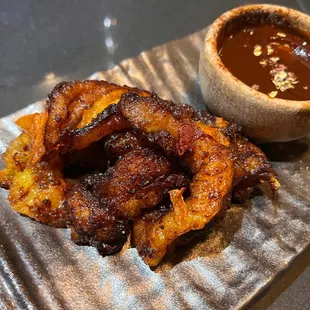 a plate of food and a bowl of sauce