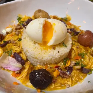 a bowl of rice with an egg on top