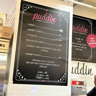  a man standing in front of a menu