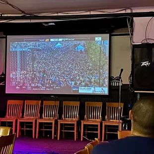 a large screen showing a football game