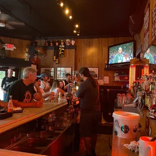 a group of people sitting at a bar
