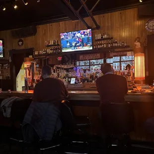 two men sitting at a bar