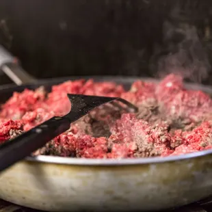 a frying pan filled with meat