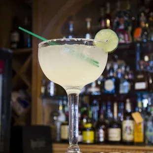 a margarita with lime garnish on the rim