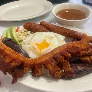 Bandeja Pueblito Paisa: Rice, beans, egg, steak, chicharrones, chorizo, morcilla, avocado, sweet plantain, salad