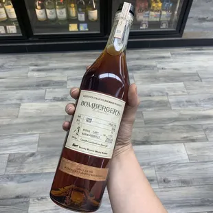 a hand holding a bottle