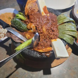 Molcajete. Been, chicken, shrimp, cheeses, opala with rice and beans