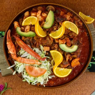 a bowl of chili, avocado, and beans