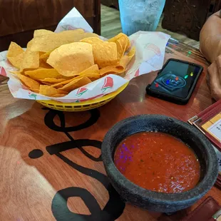 a bowl of chips and a bowl of salsa