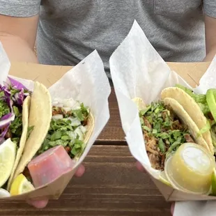 two tacoss on a table