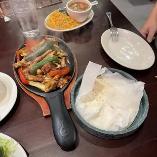 Chicken fajitas-comes with rice, pinto, and the cold plate of sour cream, pico, and guacamole, and flour tortillas.