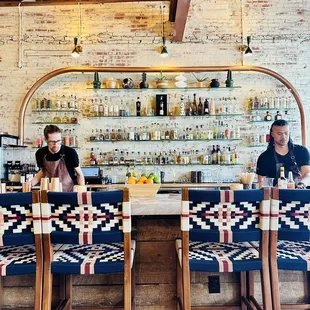 a man and a woman sitting at a bar