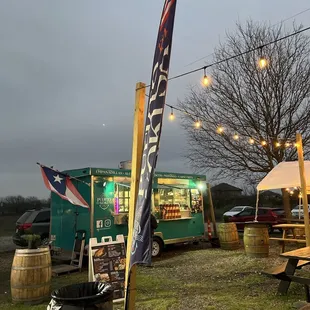 a food truck and picnic tables