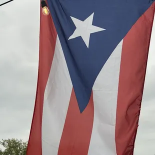 a large puerto rican flag on a pole