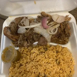 Pernil with onions, yellow rice with pigeon peas, homemade hot sauce