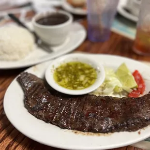 a plate of steak and rice