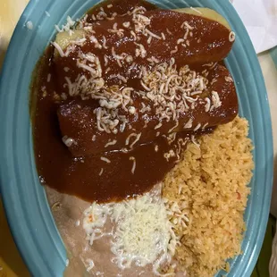 2ground beef enchiladas, rice, and beans.