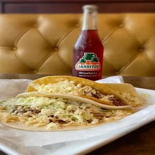 two tacos on a white plate