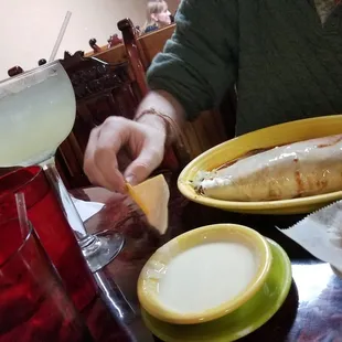 a man eating a fish and chips