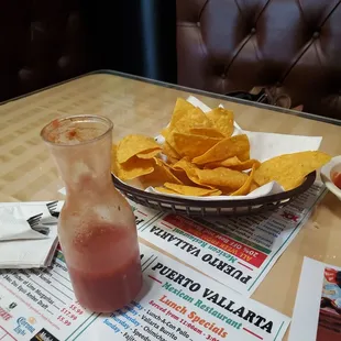 a drink and chips on a table