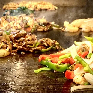a variety of food being cooked on a grill