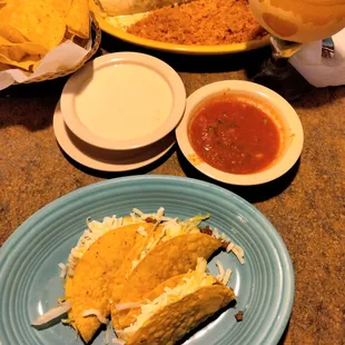 Steak burrito with rice. Beef tacos. Chips salsa and cheese dip with mango margarita