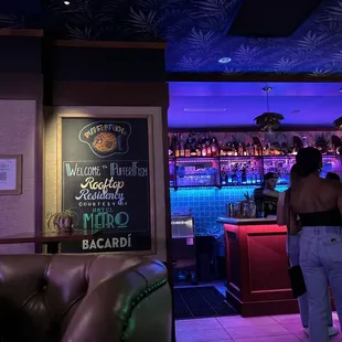 a woman standing in front of a bar