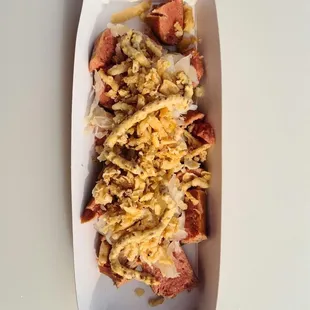 a hot dog with cheese and onions