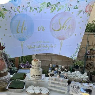 a table with a cake and cupcakes