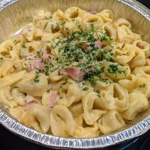 Tortellini alla Panna. Beef tortellini &amp; sauteed ham in creamy Alfredo sauce. Served with salad and bread. $12.99.