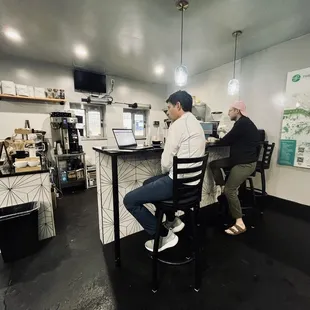 two men sitting at a bar