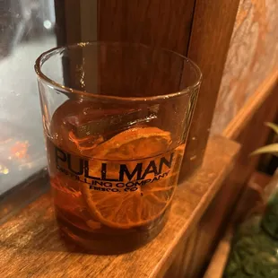a glass of whiskey on a window sill