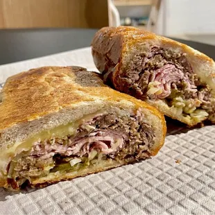 Cubano sandwich made with homemade mojo pork, prosciutto cotto, Swiss, spicy mustard, and pickles. Huge and delicious!