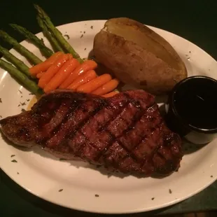 10oz New York strip special comes with baked potato honey glazed carrots, asparagus and a house salad for $18.95