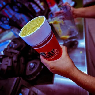 a hand holding a drink