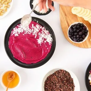 a person scooping a spoon into a smoothie