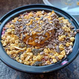 Dragonfruit bowl with granola, peanut butter and chocolate.