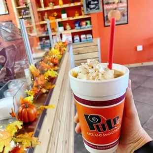 a hand holding a cup of coffee