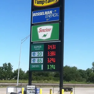 a gas station sign and a gas pump