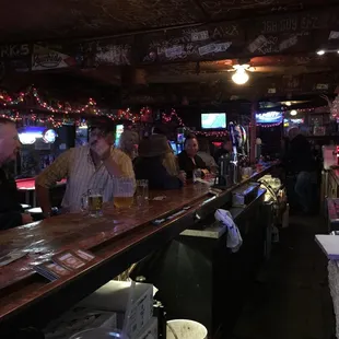a bar with people sitting at the bar