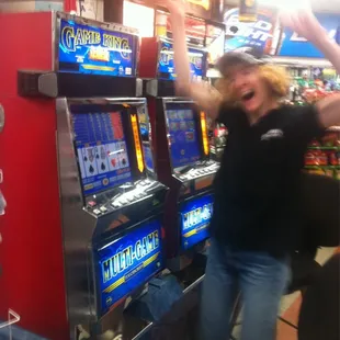 a woman standing in front of a slot machine
