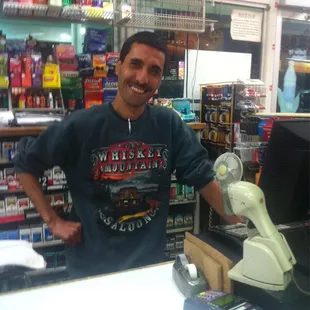 a man standing behind a cash register
